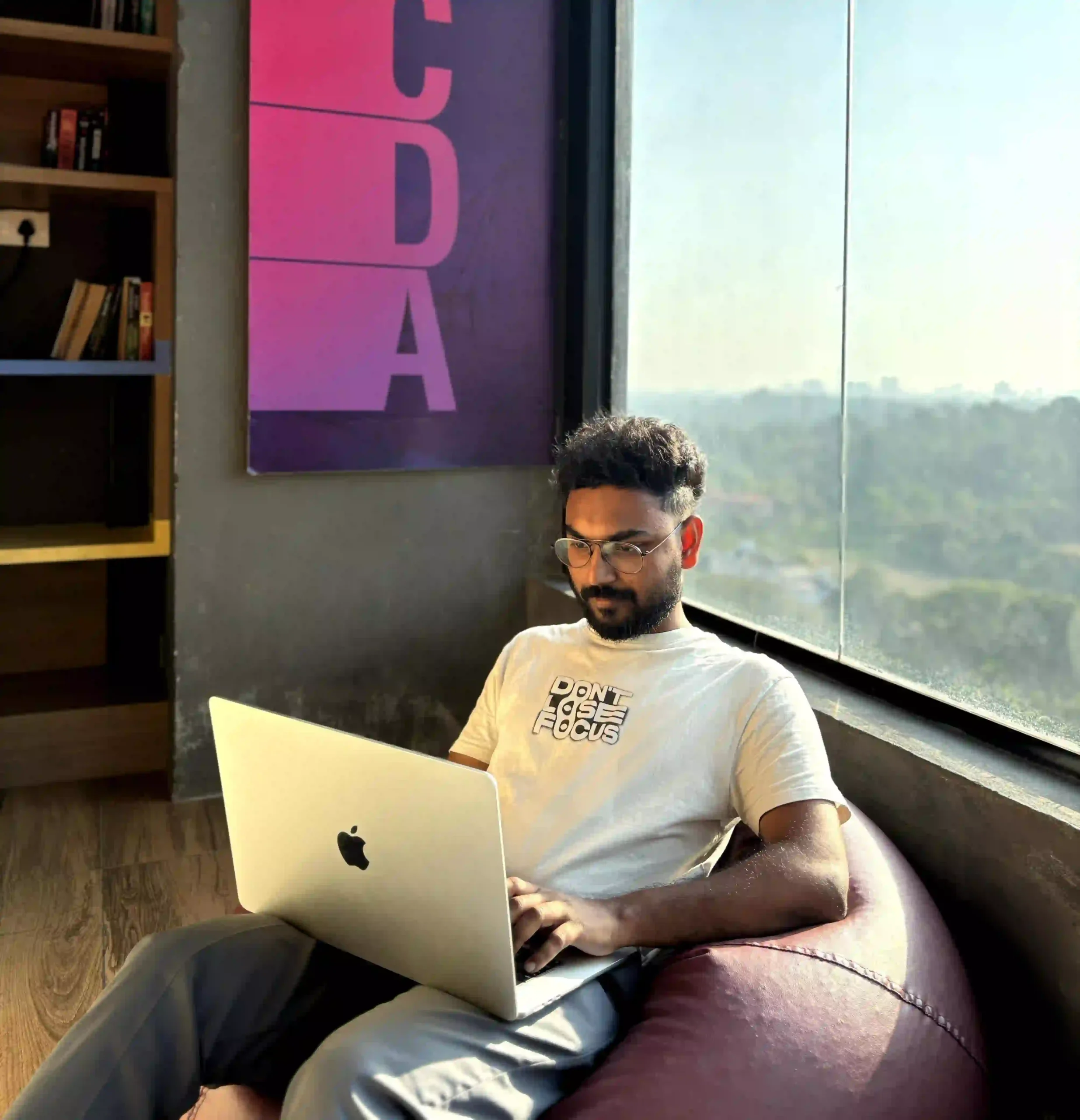 An illustration of a Freelance Digital Marketer in Palakkad working on a laptop, implementing SEO, content marketing, and social media strategies."